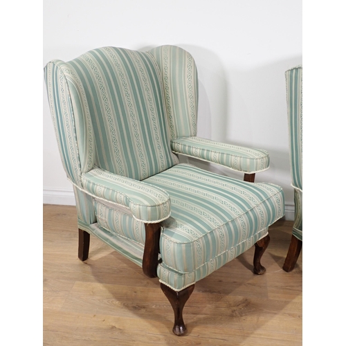 575 - A pair of blue upholstered Wingback Armchairs on cabriole supports