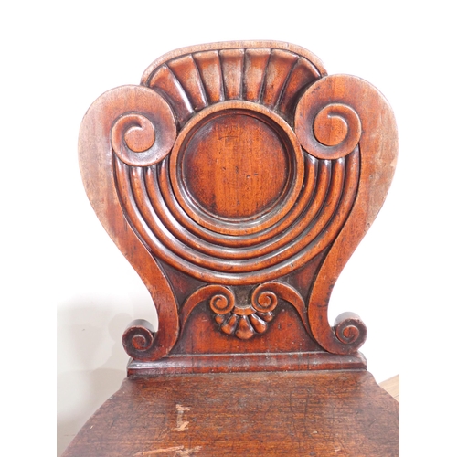 597 - A William IV mahogany Hall Chair with scroll carved back mounted upon turned supports and an Indian ... 