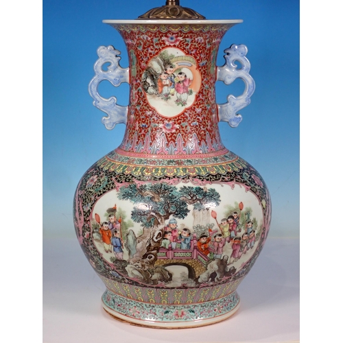 599 - A Chinese two handled Vase converted to a Table Lamp with reserves of figures 14in H (excluding ligh... 