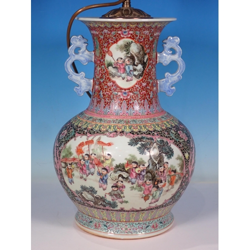 599 - A Chinese two handled Vase converted to a Table Lamp with reserves of figures 14in H (excluding ligh... 