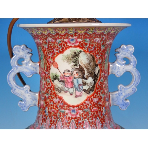 599 - A Chinese two handled Vase converted to a Table Lamp with reserves of figures 14in H (excluding ligh... 