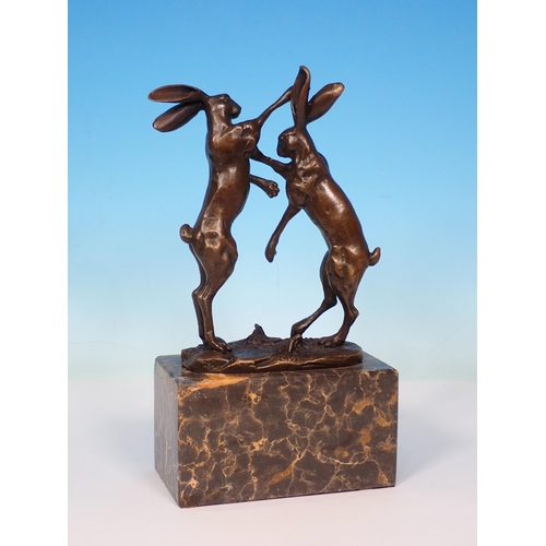 6 - A bronze Sculpture of boxing hares on green polished stone base, signed 'Nick' 9 1/2in H