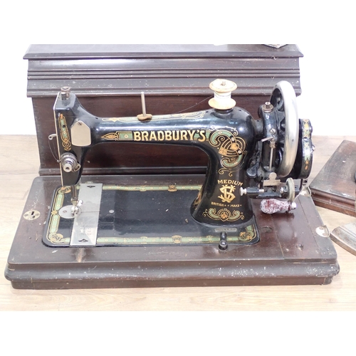 609 - A Bradbury's Sewing Machine in mahogany case, another Sewing Machine and a Flat Iron