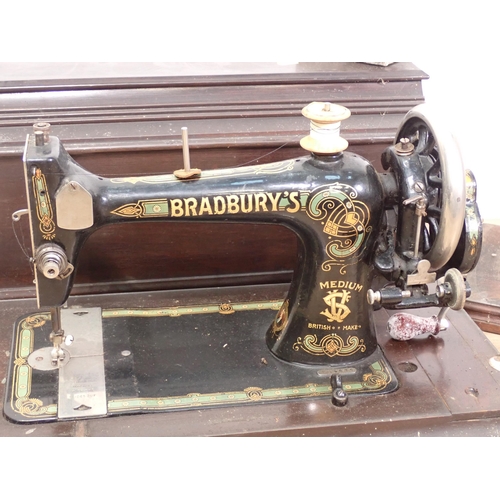 609 - A Bradbury's Sewing Machine in mahogany case, another Sewing Machine and a Flat Iron