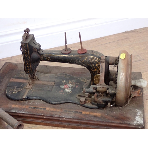 609 - A Bradbury's Sewing Machine in mahogany case, another Sewing Machine and a Flat Iron