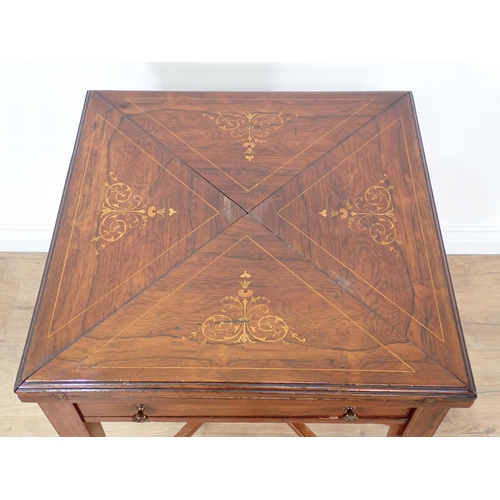 611 - A Victorian rosewood and inlaid Envelope Card Table fitted with single drawer mounted upon square cu... 