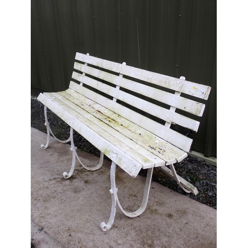 755 - A white painted wooden and wrought iron Garden Bench