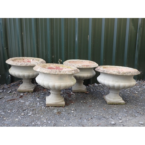 764 - Four concrete fluted pedestal Urns