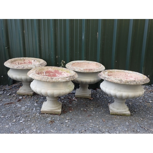 764 - Four concrete fluted pedestal Urns