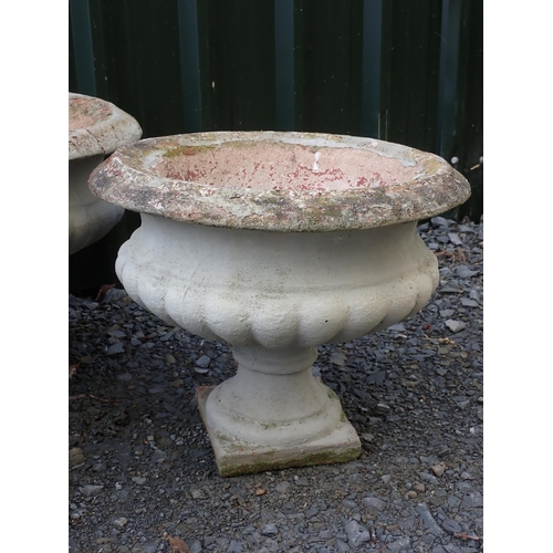 764 - Four concrete fluted pedestal Urns