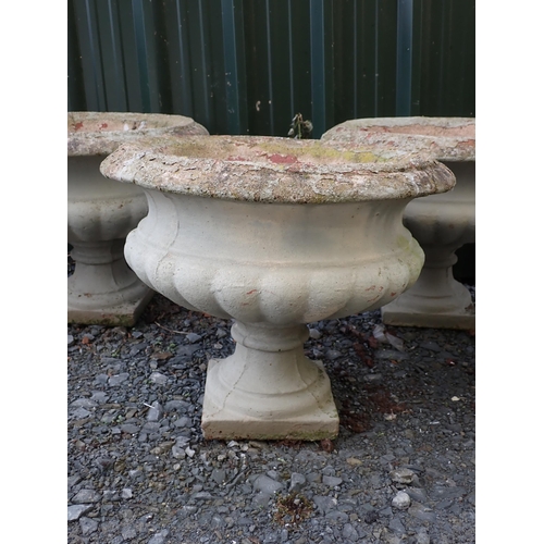 764 - Four concrete fluted pedestal Urns