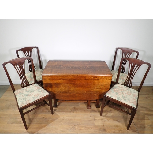 92 - An oak dropleaf Dining Table and a set of four oak Dining Chairs with pierced splat backs