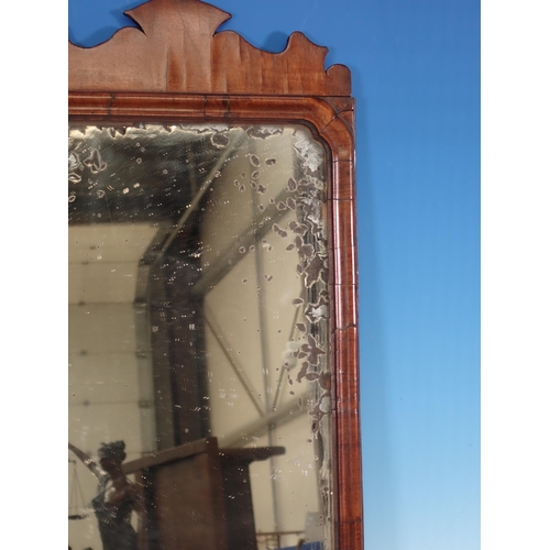 12 - An 18th Century walnut Wall Mirror with shaped frame and brass candle sconce 1ft 10in H x 11in W