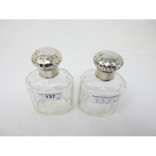 137 - A pair of George V silver lidded glass Scent Bottles with hammered design, London 1911