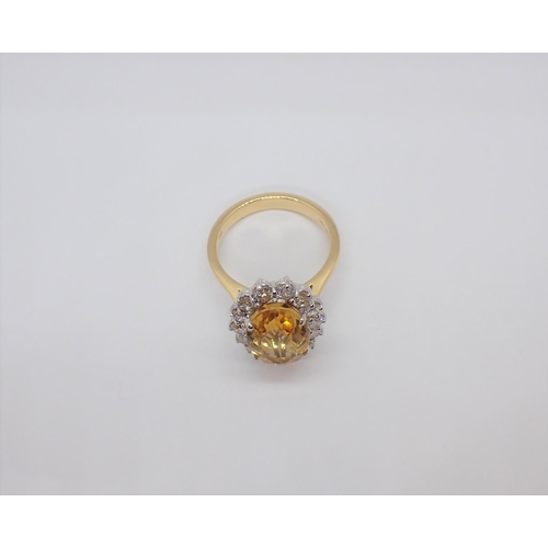 156 - A Citrine and Diamond Cluster Ring claw-set oval-cut golden citrine, 3ct, within a frame of brillian... 