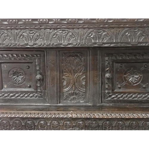 16 - An antique carved oak Court Cupboard with base converted to a bookcase with adjustable shelves 5ft 5... 