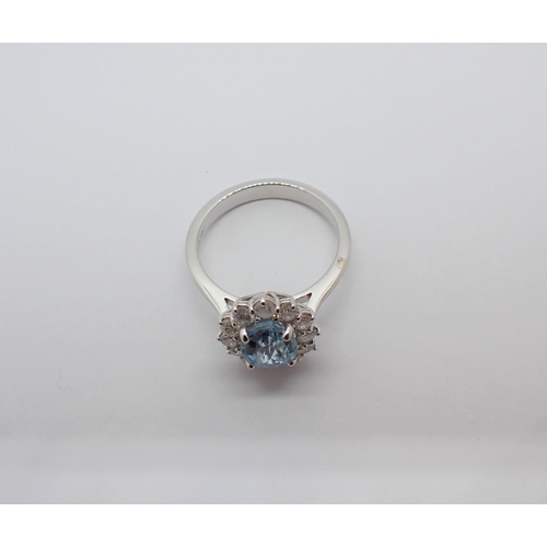 160 - An Aquamarine and Diamond Cluster Ring claw-set oval-cut aquamarine, 1.31cts, within a frame of twel... 