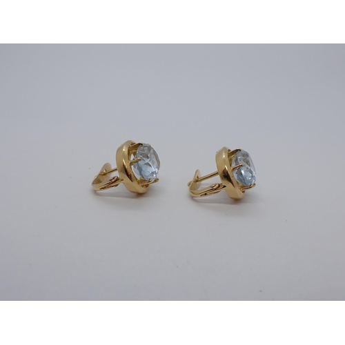 163 - A pair of Earrings each claw-set oval-cut pale blue synthetic spinel in high grade gold