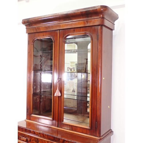 17 - A Victorian mahogany Bookcase with glazed upper section with mirrored back and glass shelves above b... 