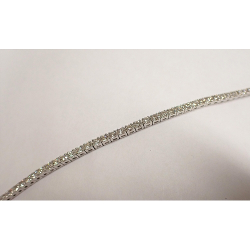 173 - A Diamond Tennis Bracelet having approx sixty eight articulated links each claw-set brilliant-cut st... 