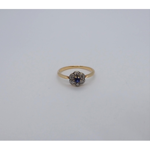 189 - A Sapphire and Diamond Cluster Ring claw-set round sapphire within six eight-cut diamonds, stamped 1... 