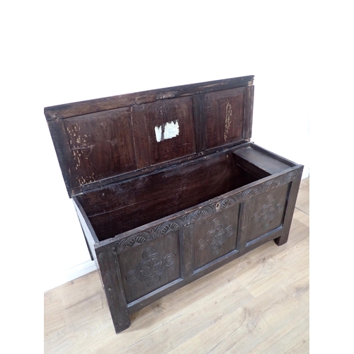 19 - A 17th Century oak Coffer of plank and joined construction with sunken three panel lid above carved ... 