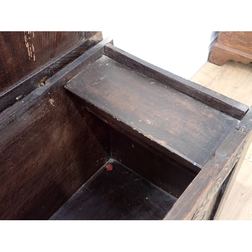 19 - A 17th Century oak Coffer of plank and joined construction with sunken three panel lid above carved ... 