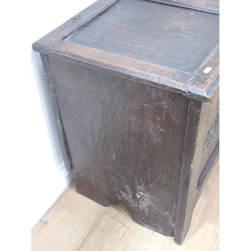 19 - A 17th Century oak Coffer of plank and joined construction with sunken three panel lid above carved ... 