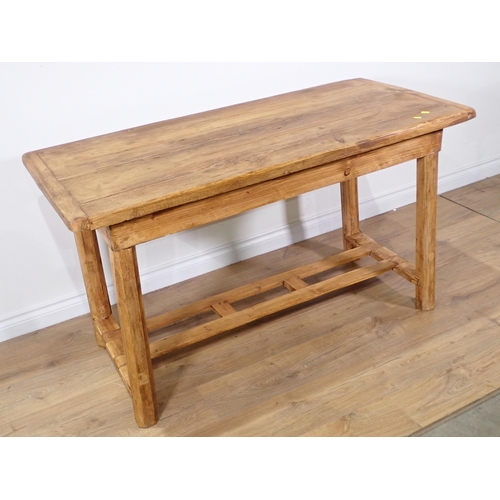 260 - A rustic pine Kitchen Table with cleated top mounted on chamfered supports with double stretcher 4ft... 