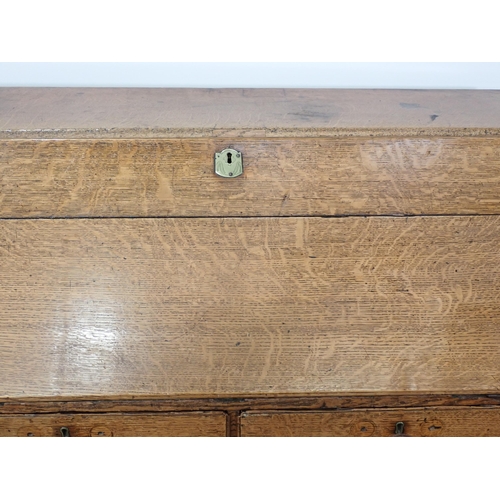 278 - A 19th Century oak Bureau with fall front enclosing interiors of drawers and a cupboard door all abo... 