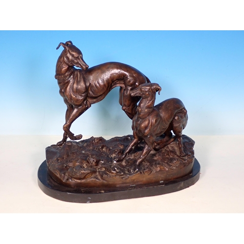 280 - A cast bronze Sculpture of two Whippets on black stone base 13in W