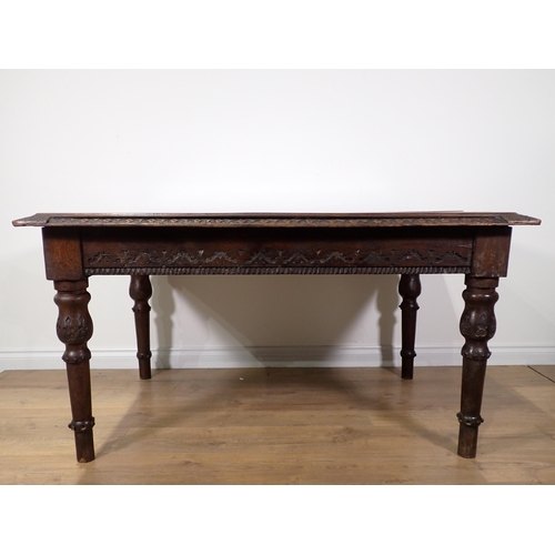 305 - A Victorian oak Library Table with carved edge and frieze mounted upon turned tapering supports 4ft ... 