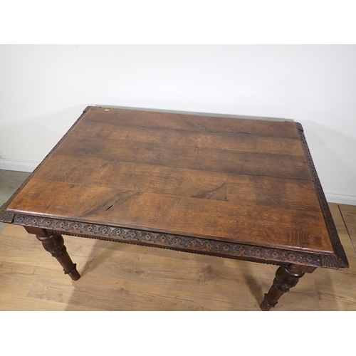 305 - A Victorian oak Library Table with carved edge and frieze mounted upon turned tapering supports 4ft ... 