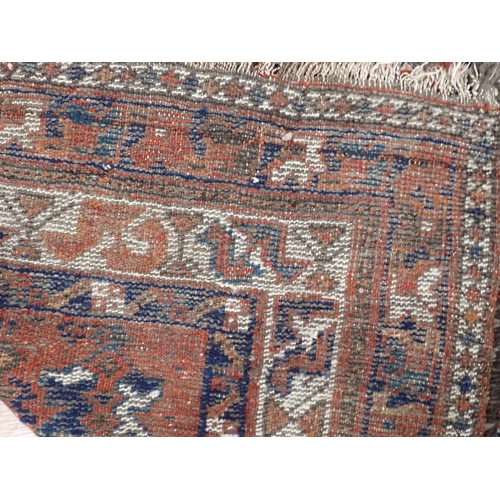 348 - A Persian Rug with multi-borders, stylised motifs and a central blue ground, 6ft x 4ft 10in