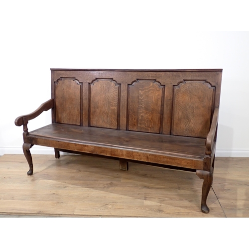 362 - An antique oak Settle with fielded panelled back on slender cabriole front supports and replacement ... 