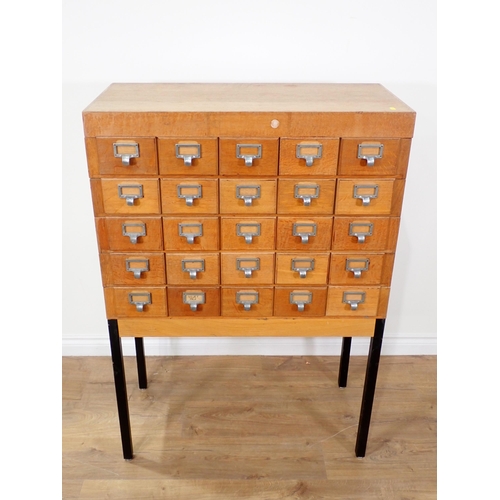 364 - A 20th Century oak bank of twenty Drawers on metal supports 4ft 1in H x 2ft 10in W