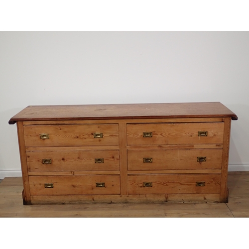 369 - An antique pine Haberdashery Shop Counter with mahogany top inset with brass ruler fitted two banks ... 