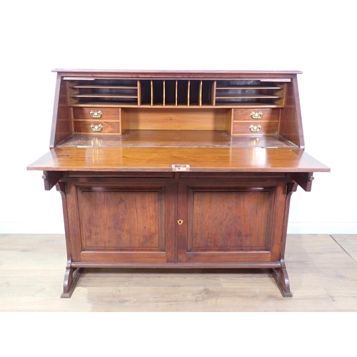 39 - An Edwardian mahogany Bureau with fall front enclosing fitted interior above pair of cupboard doors ... 