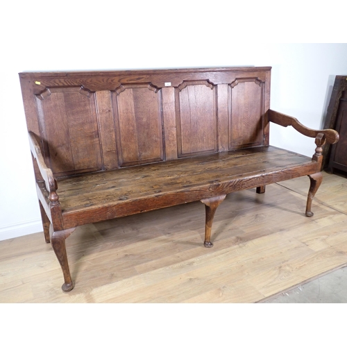 446 - An 18th Century oak Settle with fielded four panel back mounted upon three cabriole front supports 6... 