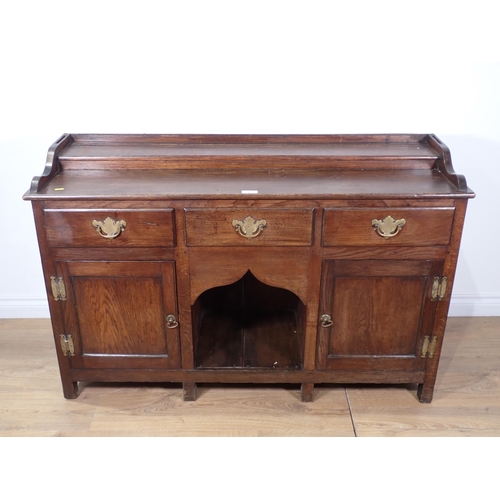 450 - An antique oak dog kennel Dresser Base in the 18th Century style fitted three drawers above a pair o... 