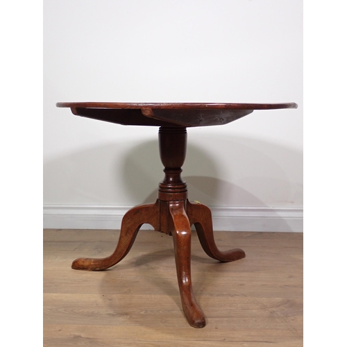 467 - An 18th Century oak low Pillar Table with circular tilt top mounted upon turned elm column on tripod... 