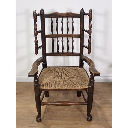 50 - An ash winged Elbow Chair with turned spindle back and rush seat and a Victorian mahogany and rosewo... 