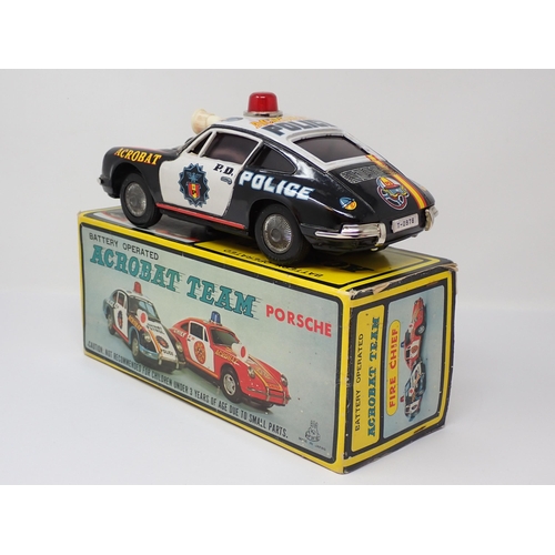 176 - A boxed battery operated Acrobat Team Porsche