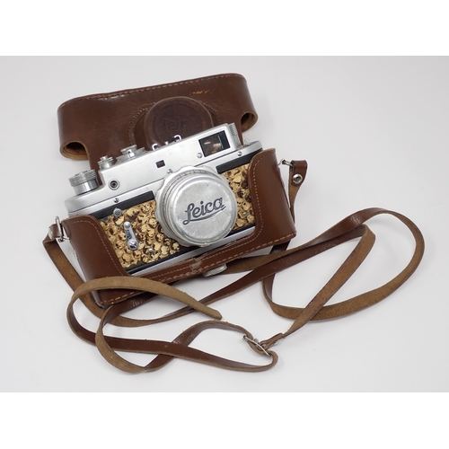 356 - A vintage Camera bearing Leica D.R.P. Ernst Leitz Wetzlar stamp and German Eagle emblem, in leather ... 