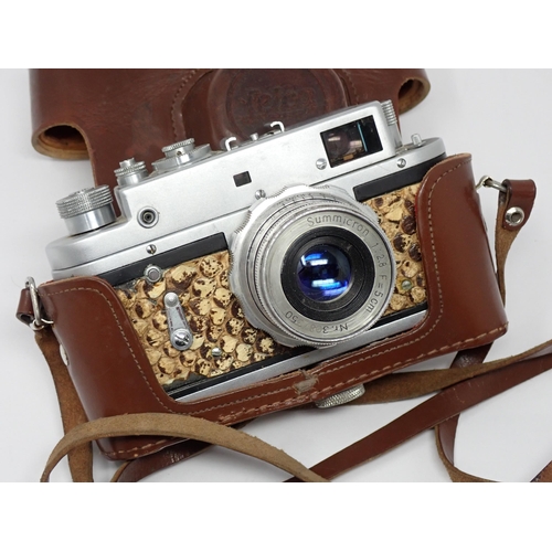 356 - A vintage Camera bearing Leica D.R.P. Ernst Leitz Wetzlar stamp and German Eagle emblem, in leather ... 