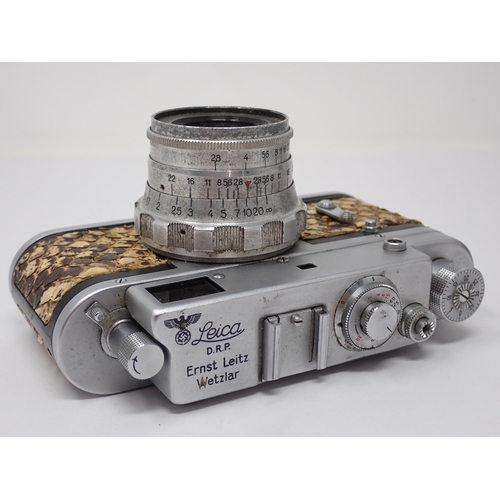 356 - A vintage Camera bearing Leica D.R.P. Ernst Leitz Wetzlar stamp and German Eagle emblem, in leather ... 