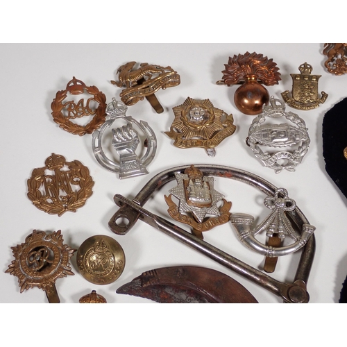 390 - A quantity of military Cap and Shoulder Badges and Buttons including The Border Regiment, East Yorks... 