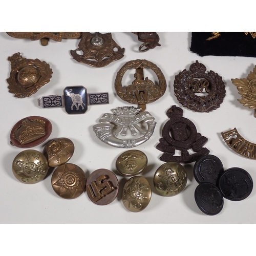 390 - A quantity of military Cap and Shoulder Badges and Buttons including The Border Regiment, East Yorks... 