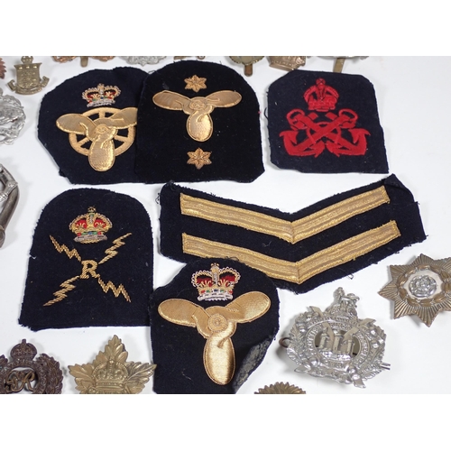 390 - A quantity of military Cap and Shoulder Badges and Buttons including The Border Regiment, East Yorks... 