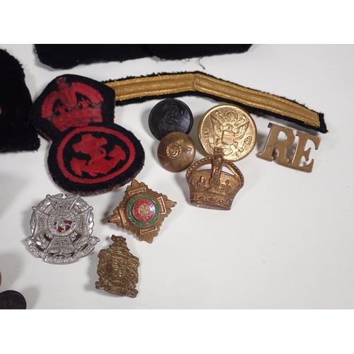 390 - A quantity of military Cap and Shoulder Badges and Buttons including The Border Regiment, East Yorks... 